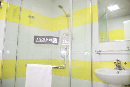 a bathroom with a glass shower and a sink at 7Days Inn Foshan Zumiao Baihua Plaza in Foshan