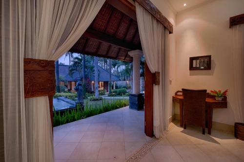 an open door to a room with a desk in a house at Saba Villa by Sanga Sanga Hospitality in Saba