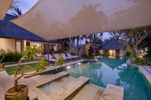a swimming pool with lounge chairs and a house at Saba Villa by Sanga Sanga Hospitality in Saba