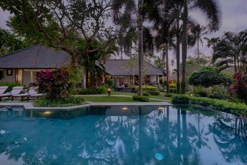 a swimming pool in front of a house at Saba Villa by Sanga Sanga Hospitality in Saba