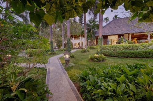 a garden with a pathway leading to a house at Saba Villa by Sanga Sanga Hospitality in Saba