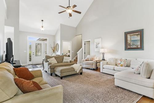 a living room with white furniture and a ceiling fan at Fairview Vista by AvantStay 10 Mins to Asheville in Fairview