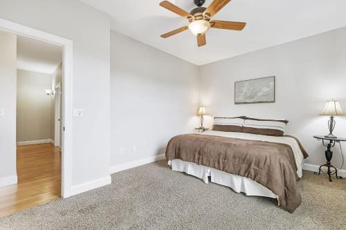 a bedroom with a bed and a ceiling fan at Fairview Vista by AvantStay 10 Mins to Asheville in Fairview