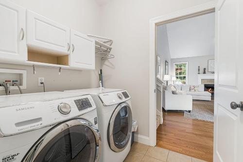 a white laundry room with a washer and dryer at Fairview Vista by AvantStay 10 Mins to Asheville in Fairview