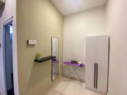 a room with a purple table and a mirror at 2 Storey Stylish Comfort Retreat ````AlmaImpianRia in Bukit Mertajam