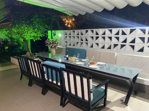 a dining table and chairs in a restaurant with a table and chairs at M Villa Nha Trang in Nha Trang