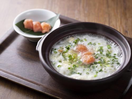 a bowl of soup on a tray with a plate of food at Hotel Wing International Select Hakata-Ekimae in Fukuoka