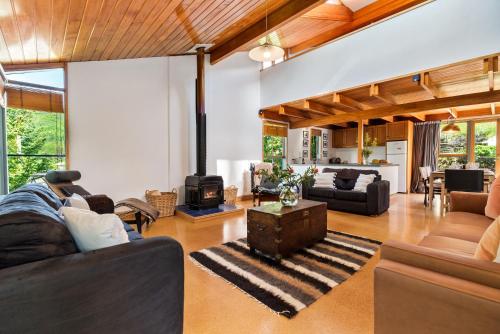 a living room filled with furniture and a fireplace at On Village Green in Arrowtown