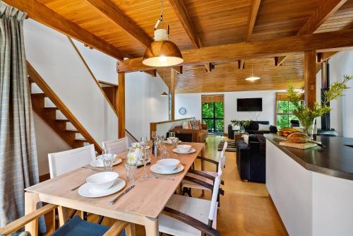 a dining room with a wooden table and chairs at On Village Green in Arrowtown