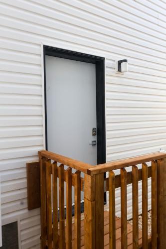 a door to a building with a wooden porch at Peaceful stay near transcona trails in Winnipeg