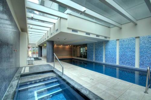 an indoor swimming pool with a large swimming poolvisor at Liberty 727 -Glenelg- Marina & City Views in Glenelg