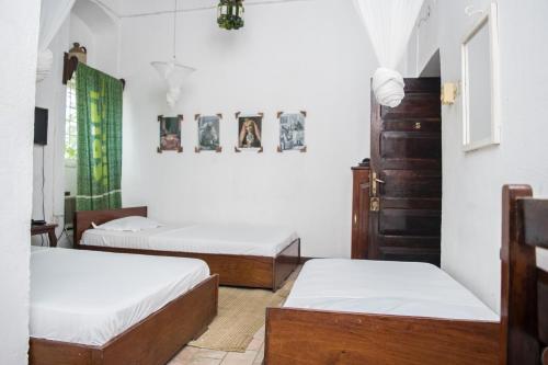 Postel nebo postele na pokoji v ubytování Malindi Guest House