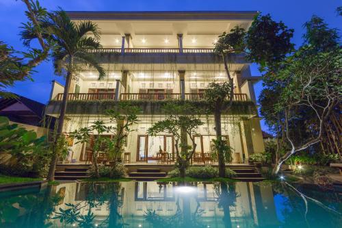 a building with a pool in front of it at The Tunjung Ubud Retreat in Ubud