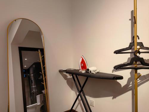 a mirror on a stand next to a shelf at K Avenue Modern Style Studio (5 Mins to Airport) in Kota Kinabalu