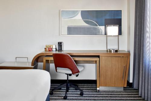 a room with a desk with a chair and a lamp at Courtyard by Marriott Nashville Downtown in Nashville