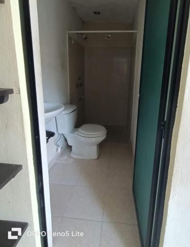 a bathroom with a toilet and a sink at Hotel la paloma in Izamal