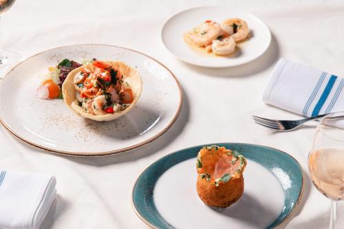 a white table with plates of food on it at Le Méridien Hong Kong, Cyberport in Hong Kong
