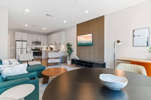 a living room with a table and a kitchen at 1BD - Sleeps 4 - Harbor Views - Near Fish Town- in Philadelphia
