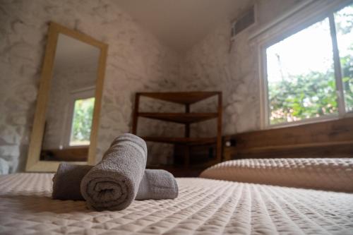 a bedroom with two rolled towels on a bed at Las Golondrinas Ayampe in Ayampe