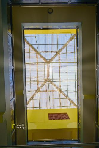 a large window in a room with a yellow wall at Big Tusks Hotel, Marsabit in Marsabit