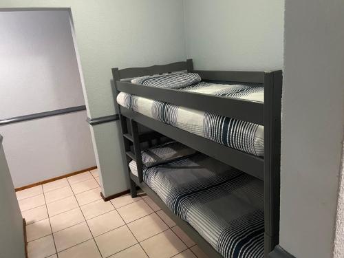 a room with three bunk beds in a refrigerator at Pendleberry Grove Unit 8 in Bela-Bela