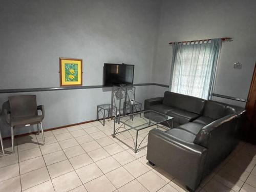 a living room with a couch and a tv at Pendleberry Grove Unit 8 in Bela-Bela