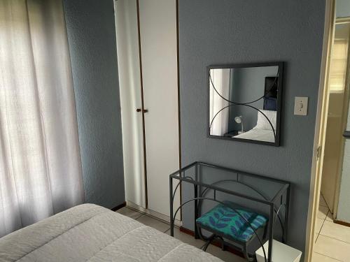 a bedroom with a bed and a mirror at Pendleberry Grove Unit 8 in Bela-Bela