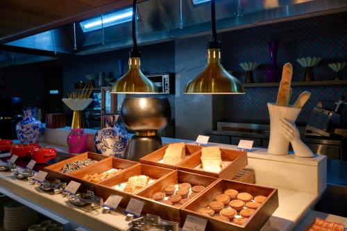 a bakery with breads and pastries on a counter at Sarovar Premiere Amritsar in Amritsar