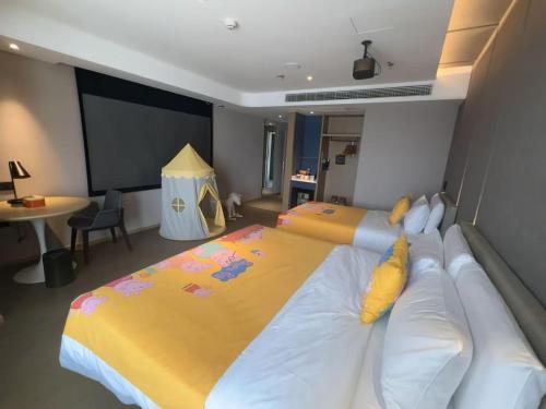 a bedroom with a large bed with a yellow blanket at Atour Hotel Ya an Era Street in Ya'an