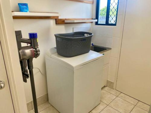 a washing machine with a basket on top of it at Charming Abode on Brenton in Tropical North Queensland in Night jar