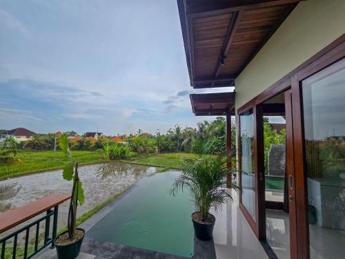 a view of a pool from the balcony of a house at Uma Jala Villa Ubud in Ubud