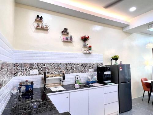 a kitchen with a counter and a refrigerator at Mountain View 606 in Langkawi Islands