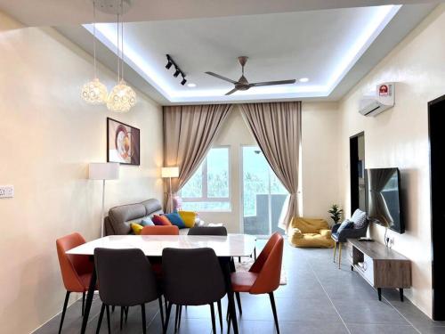 a living room with a table and chairs and a couch at Mountain View 606 in Langkawi Islands
