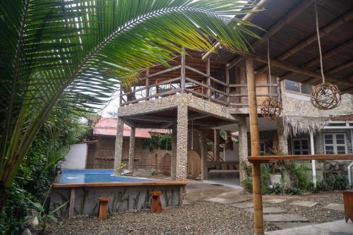 a house with a swimming pool in front of it at Las Golondrinas Ayampe in Ayampe