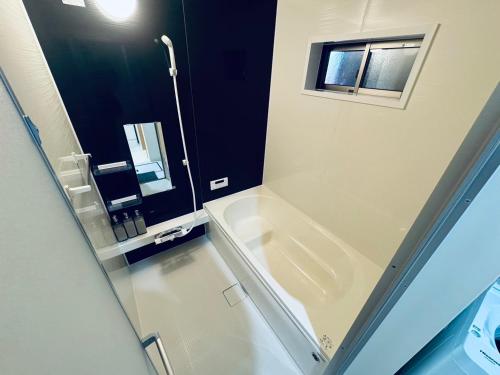 a bathroom with a shower and a sink and a mirror at BETTEi 別邸 in Okayama