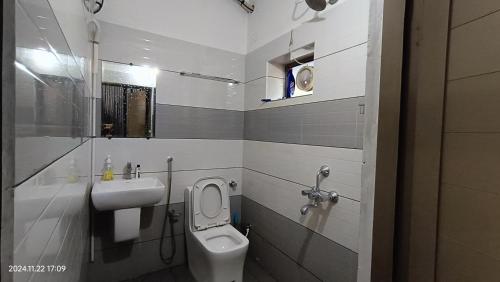 a bathroom with a toilet and a sink at Aroma Serviced Villa Cochin in Ernakulam