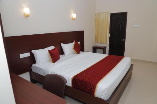a bedroom with a large bed with red pillows at YMCA PROGRAM CENTRE in Salem