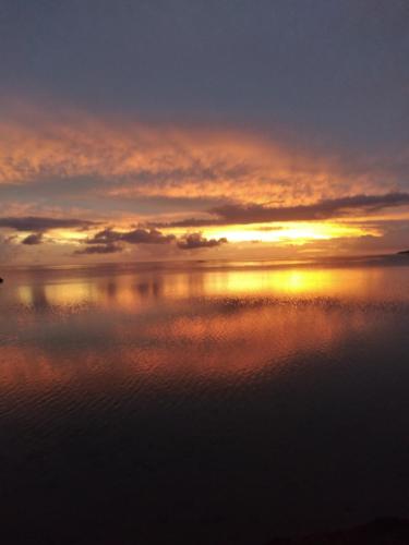 a sunset over a body of water with the sky at Maupiti Authentique in Te-Fare-Arii