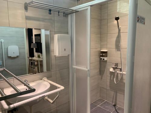 a bathroom with a shower and a sink at Bluewater Hotel Xpark Gloria Outlets Taoyuan Baseball Stadium in Dayuan