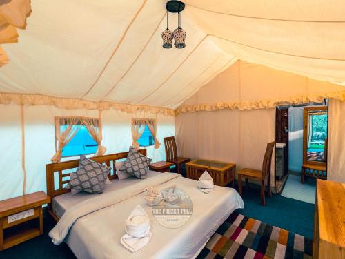 a bedroom with two beds in a tent at Dawat-e-Drung by FrozenFall Resort in Gulmarg