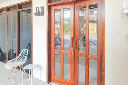 a pair of glass doors on a building at RedDoorz at Anjasmoro Guest House near Bandara Ahmad Yani Semarang in Kalibanteng-lor