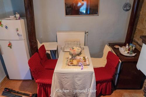 a table with red chairs and a plate of food on it at Villa Norma in Órma