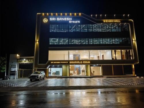 a car parked in front of a building at night at SG Mahal & Rooms in Kanyakumari