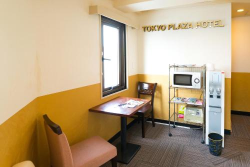 a small room with a table and a microwave at Tokyo Plaza Hotel in Tokyo
