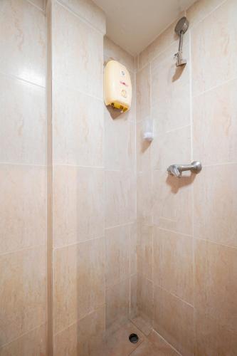 a bathroom with a shower with a shower head at Abunawas Merry Inn at Walking Street in Pattaya South