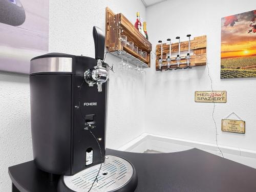 a black coffee maker sitting on a table at Gruppenfreundl Komfort Apt für 18 im Zentrum Stuttgarts in Stuttgart