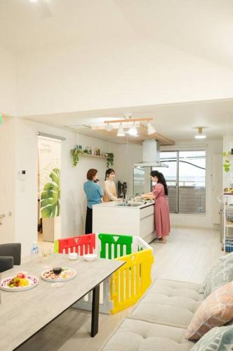 a group of people preparing food in a kitchen at 美らVacation in Onna