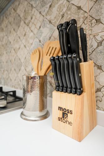 a knife block with a bunch of knives on a counter at Elite Residence 7 Star Luxe Condo with Gym and Pool next to JW Marriott, Westlands Airport Shuttle, Luggage Storage available in Nairobi