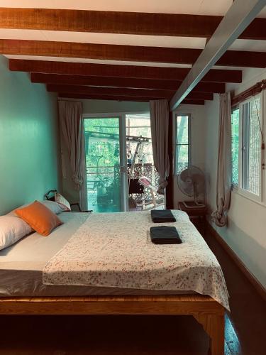 a bedroom with a large bed and a large window at Gumm Lonely Club in Ko Kood