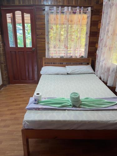 a bed in a room with at Leianna's Homestay in Port Barton